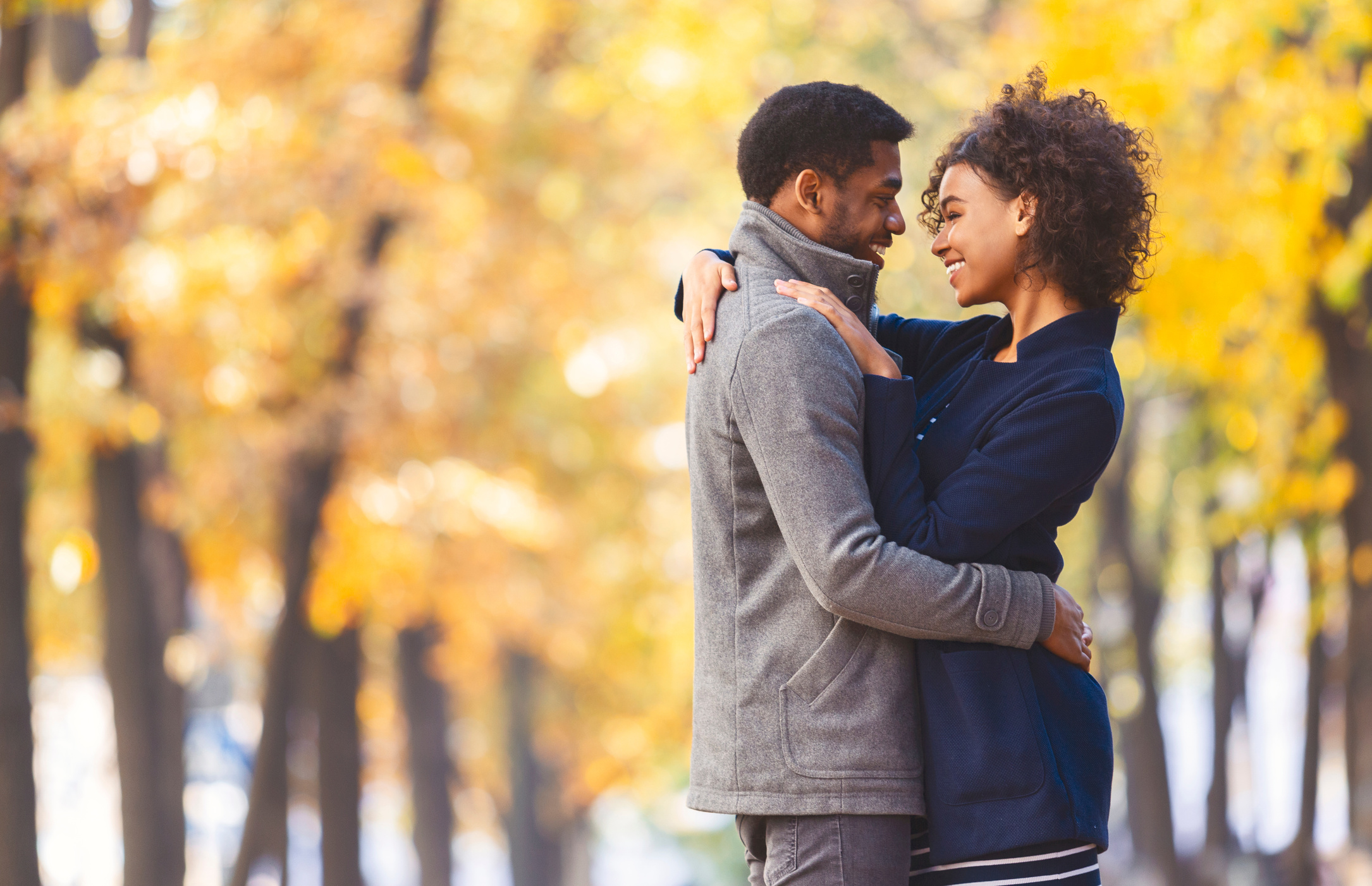 Sweet black couple hugging in autumn park